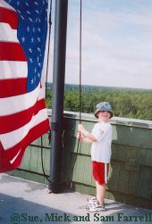 Sam Farrell lowering Wilderness Lodge flag