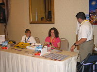 Renee Block looks on as Deanna and Lou Mongello set up